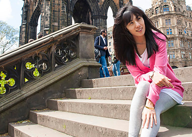 Woman tourist on steps beside Scott Monument